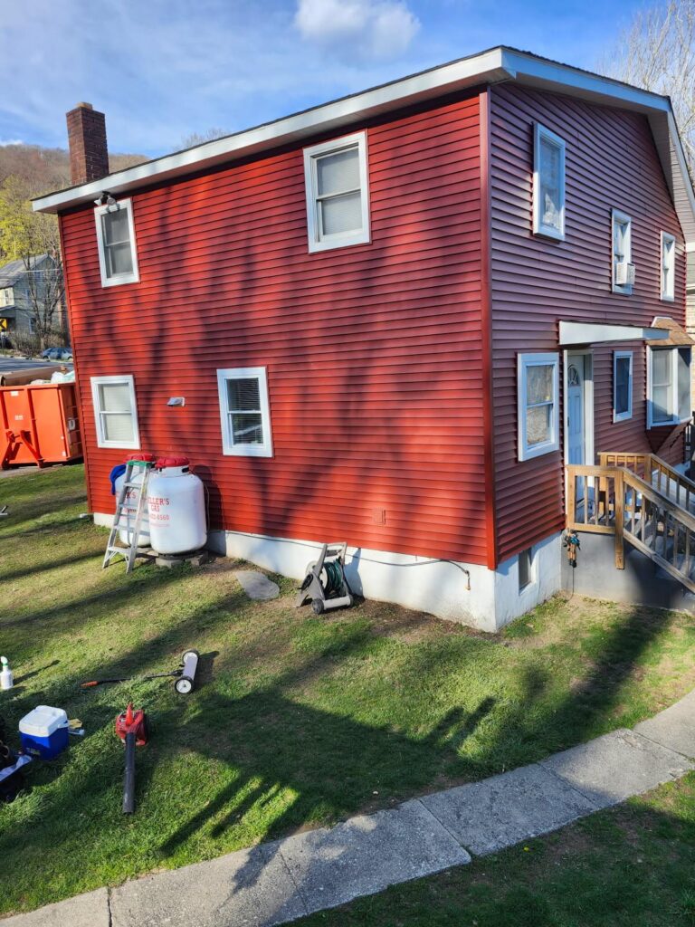 house with red siding and new hung windows.